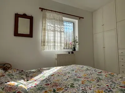 a bedroom with a bed and a window at Seaview Haven in Sounio
