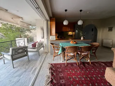 a kitchen and dining room with a table and chairs at Seaview Haven in Sounio