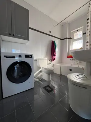 a bathroom with a washing machine and a toilet at Seaview Haven in Sounio
