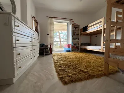 a bedroom with two bunk beds and a rug at Seaview Haven in Sounio