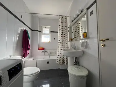 a white bathroom with a toilet and a sink at Seaview Haven in Sounio