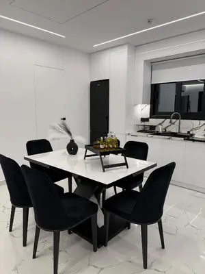 a dining room with a white table and black chairs at S&P-elegant suite with jacuzzi in Athens