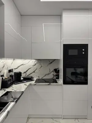 a kitchen with white cabinets and a black microwave at S&P-elegant suite with jacuzzi in Athens