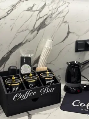 a black coffee bar box with a set of products at S&P-elegant suite with jacuzzi in Athens