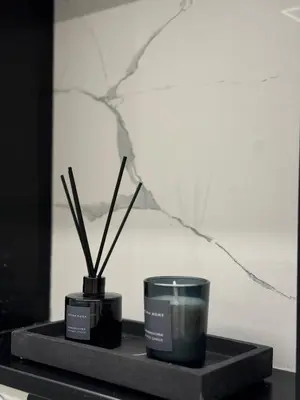 two candles and a candle holder on a table at S&P-elegant suite with jacuzzi in Athens
