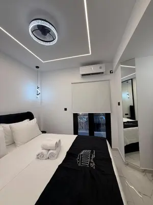 a bedroom with a bed with two towels on it at S&P-elegant suite with jacuzzi in Athens