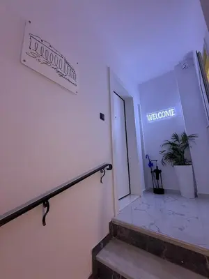 a staircase in a building with a sign on the wall at S&P-elegant suite with jacuzzi in Athens