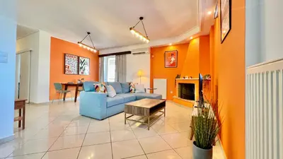 a living room with a blue couch and a table at Seaside Central 3bdr Apt with sea views in Athens