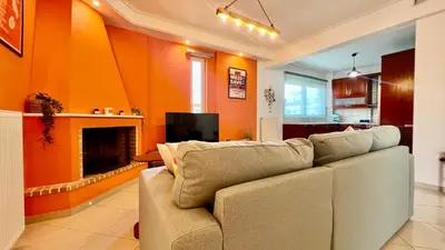 a living room with a couch and a fireplace at Seaside Central 3bdr Apt with sea views in Athens