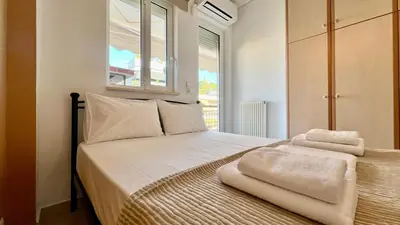 a bedroom with a bed with towels on it at Seaside Central 3bdr Apt with sea views in Athens