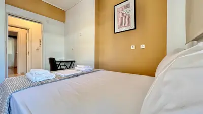 a bedroom with a bed with two towels on it at Seaside Central 3bdr Apt with sea views in Athens