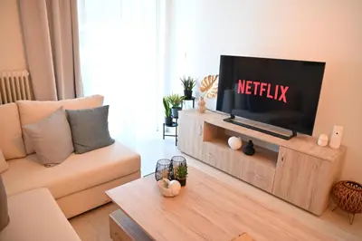 a living room with a flat screen tv on a entertainment center at Athénée Retreat in Athens