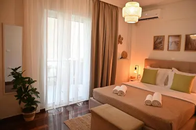 a bedroom with two beds and a large window at Athénée Retreat in Athens
