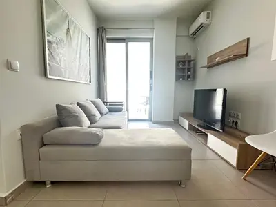 a living room with a couch and a tv at Minimal City Retreat in Western Athens in Athens
