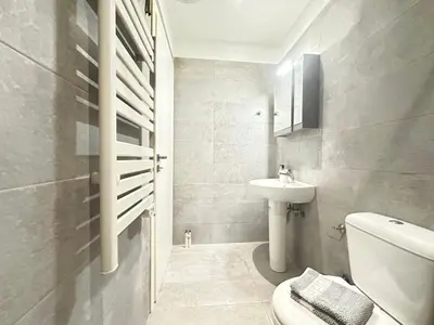 a white bathroom with a sink and a toilet at Minimal City Retreat in Western Athens in Athens