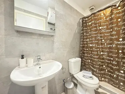 a bathroom with a sink and a toilet with writing on the wall at Minimal City Retreat in Western Athens in Athens