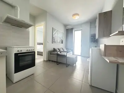 a kitchen and living room with a stove and a couch at Minimal City Retreat in Western Athens in Athens
