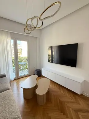 a living room with a flat screen tv on a wall at The Kallion Kolonaki Athens in Athens