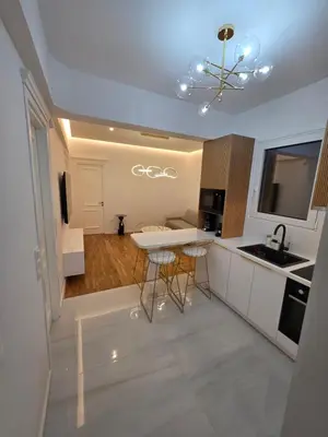 a kitchen with a table and chairs in a room at The Kallion Kolonaki Athens in Athens