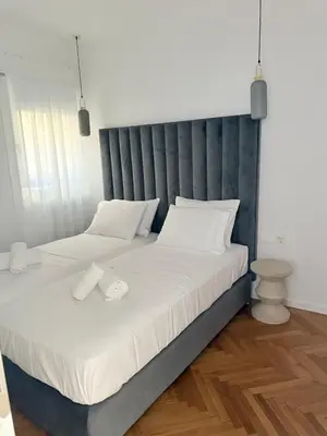a bedroom with two beds with white sheets at The Kallion Kolonaki Athens in Athens