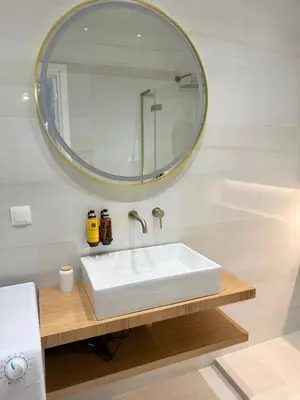 a bathroom with a white sink and a mirror at The Kallion Kolonaki Athens in Athens