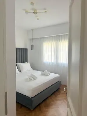 a bedroom with a bed with two towels on it at The Kallion Kolonaki Athens in Athens