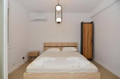 a bedroom with a bed in a white room at Athenian Riviera budget friendly 2 minutes to the beach tram in Athens