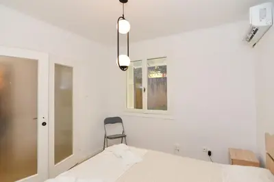a room with a bed and a chair and a window at Athenian Riviera budget friendly 2 minutes to the beach tram in Athens