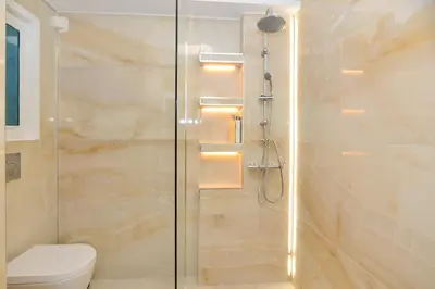 a bathroom with a glass shower with a toilet at Athenian Riviera budget friendly 2 minutes to the beach tram in Athens