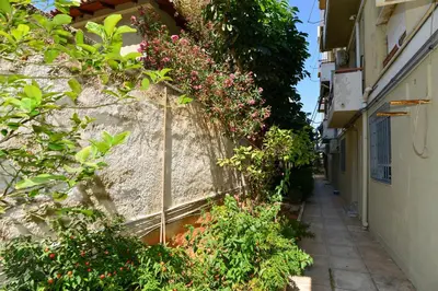 an alley with flowers on the side of a building at Athenian Riviera budget friendly 2 minutes to the beach tram in Athens