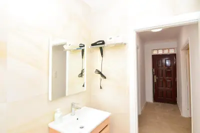 a bathroom with a sink and a mirror at Athenian Riviera budget friendly 2 minutes to the beach tram in Athens