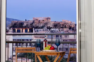 a table with fruit on it with a view ofhens at Livinn Acropolis View in Athens