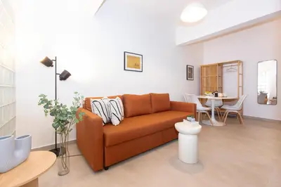 a living room with a couch and a table at Livinn Acropolis View in Athens
