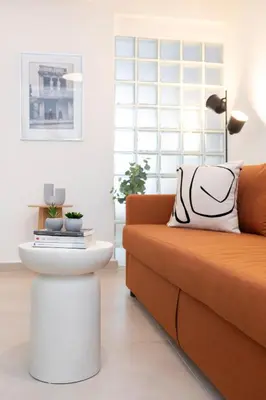 a living room with a couch and a coffee table at Livinn Acropolis View in Athens