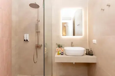 a bathroom with a sink and a shower at Livinn Acropolis View in Athens