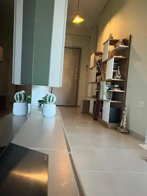 a living room with two potted plants on the floor at Christiana Luxury Apartments in Palaiá Fókaia