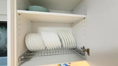 a cupboard filled with white plates and bowls at Filellinon in Athens