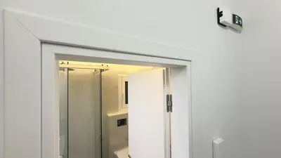 a shower door in a bathroom with a mirror at Filellinon in Athens