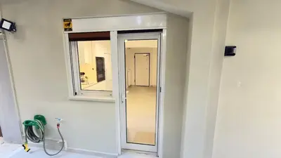 a bathroom with a window in a white wall at Filellinon in Athens