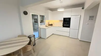 a kitchen with white appliances and a table and chairs at Filellinon in Athens