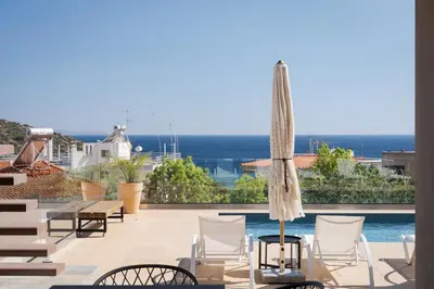 a view of a patio with chairs and a pool at Villa Nefeli Athenian Riviera in Anavissos