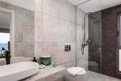 a bathroom with a tub and a toilet and a shower at Villa Nefeli Athenian Riviera in Anavissos