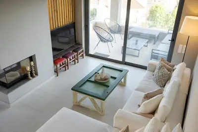 a living room with a couch and a table at Villa Nefeli Athenian Riviera in Anavissos