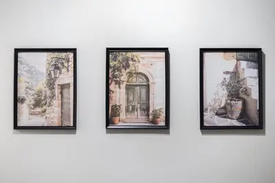 a group of four framed photos on a wall at Tiko Nina by Greece Apartments in Athens