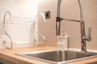 a kitchen sink with a water faucet at Tiko Nina by Greece Apartments in Athens