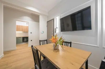 a dining room table with a vase of flowers on it at Tiko Nina by Greece Apartments in Athens