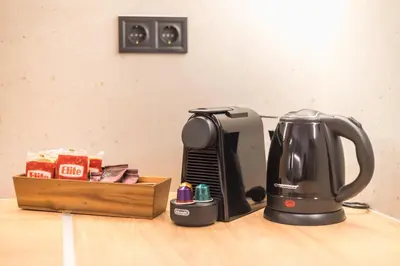 a coffee maker sitting on a counter next to a box at Tiko Nina by Greece Apartments in Athens