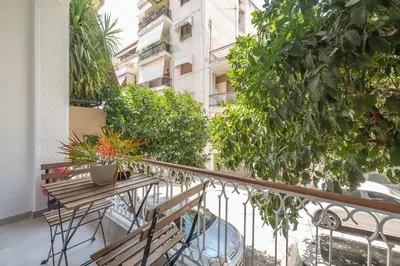 a balcony with benches and plants on a building at Tiko Nina by Greece Apartments in Athens
