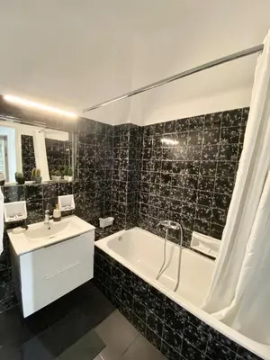 a bathroom with a tub and a sink at Kypseli Modern Nest in Athens