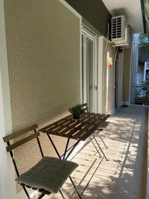 a pair of chairs and a table on a patio at Kypseli Modern Nest in Athens